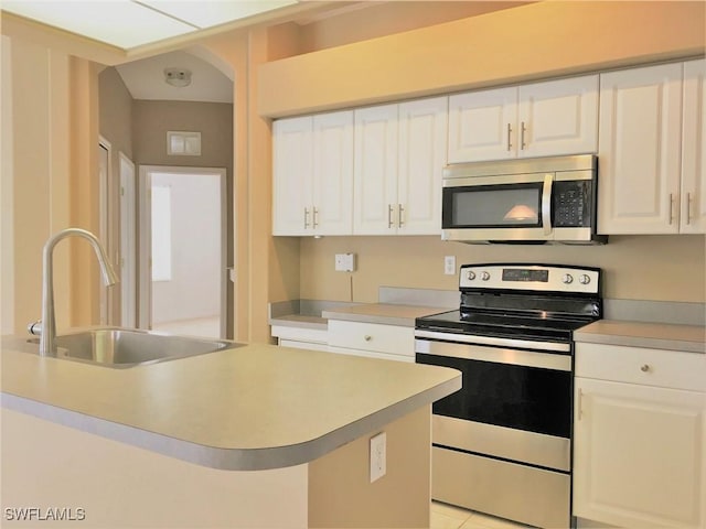 1820 SW 29th Ter, Cape Coral, FL 33914 - kitchen with stainless steel appliances, a sink, light countertops, and white cabinets