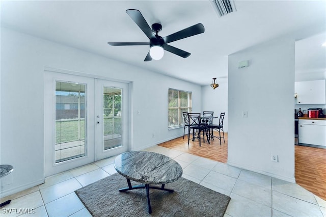 911 Medford Ave S, Lehigh Acres, FL 33974 - living area featuring french doors, light tile patterned floors, a ceiling fan, and baseboards