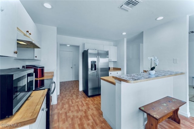 911 Medford Ave S, Lehigh Acres, FL 33974 - kitchen featuring stainless steel appliances, under cabinet range hood, a peninsula, white cabinetry, and light wood-type flooring