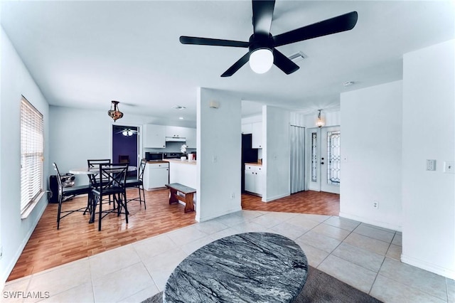911 Medford Ave S, Lehigh Acres, FL 33974 - living area featuring light tile patterned flooring, a ceiling fan, and baseboards