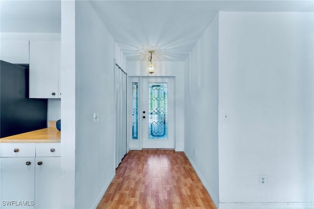 911 Medford Ave S, Lehigh Acres, FL 33974 - entrance foyer with light wood-style flooring and baseboards
