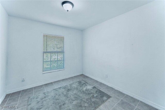 911 Medford Ave S, Lehigh Acres, FL 33974 - unfurnished room featuring tile patterned flooring and baseboards