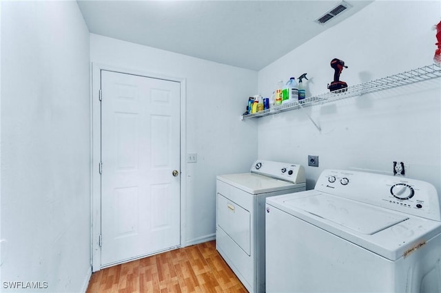 911 Medford Ave S, Lehigh Acres, FL 33974 - washroom with washing machine and dryer, light wood-type flooring, and baseboards