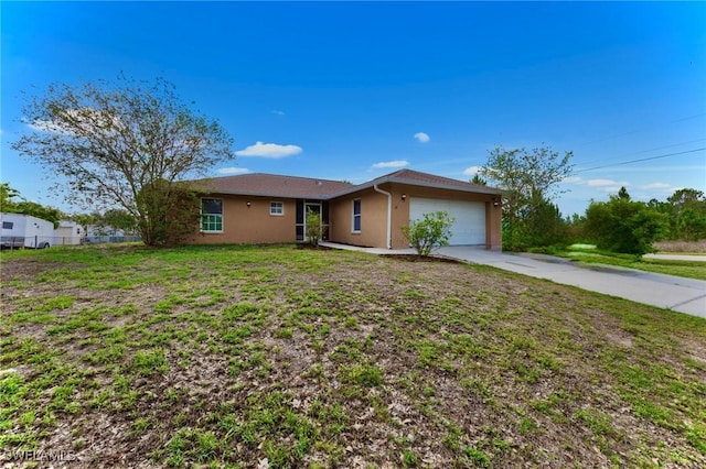 911 Medford Ave S, Lehigh Acres, FL 33974 - ranch-style house with an attached garage, stucco siding, and driveway