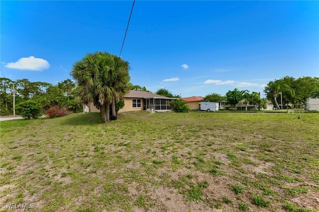 911 Medford Ave S, Lehigh Acres, FL 33974 - view of green lawn featuring a sunroom