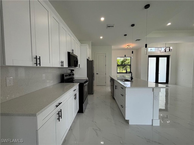 kitchen featuring appliances with stainless steel finishes, white cabinetry, hanging light fixtures, recessed lighting, and a spacious island