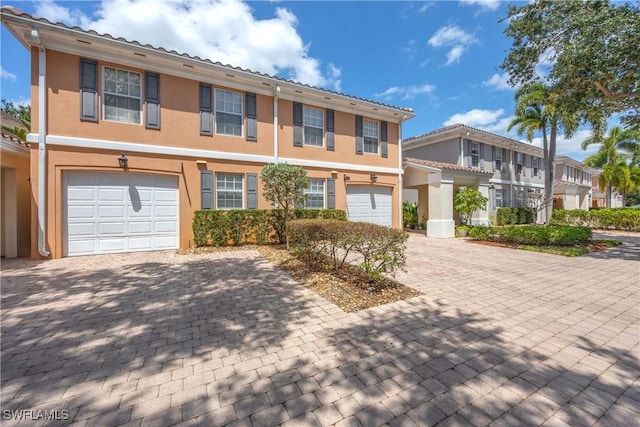 5831 Cove Cir Unit 6, Naples, FL 34119 - multi unit property with decorative driveway, an attached garage, stucco siding, and a residential view