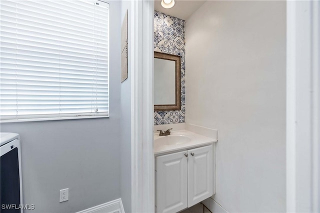 5831 Cove Cir Unit 6, Naples, FL 34119 - half bathroom featuring vanity and washer and clothes dryer