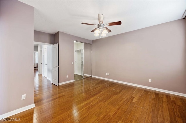 5831 Cove Cir Unit 6, Naples, FL 34119 - empty room featuring baseboards, a ceiling fan, and wood finished floors