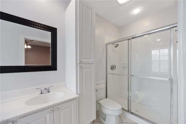 5831 Cove Cir Unit 6, Naples, FL 34119 - full bath with toilet, a shower stall, vanity, a ceiling fan, and tile patterned floors