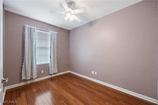 5831 Cove Cir Unit 6, Naples, FL 34119 - unfurnished room with dark wood-type flooring, baseboards, and a ceiling fan