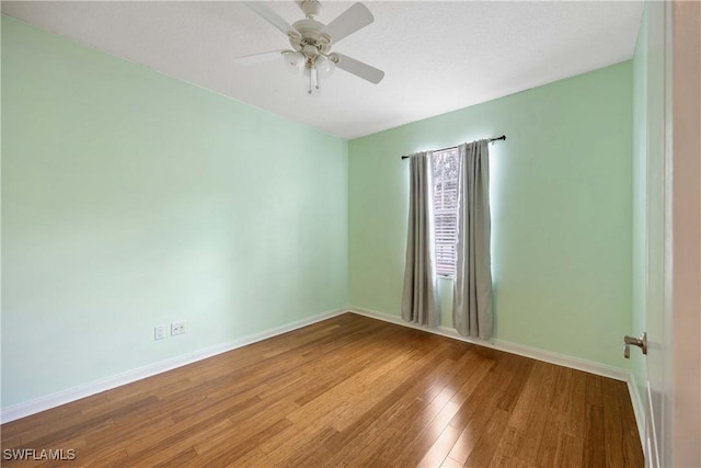 5831 Cove Cir Unit 6, Naples, FL 34119 - empty room with wood finished floors, baseboards, and a ceiling fan