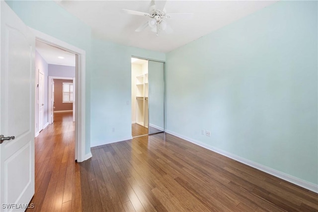 5831 Cove Cir Unit 6, Naples, FL 34119 - unfurnished bedroom featuring a closet, hardwood / wood-style flooring, baseboards, and ceiling fan