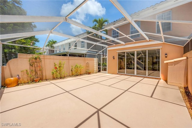 5831 Cove Cir Unit 6, Naples, FL 34119 - back of house with stucco siding, a patio area, and glass enclosure