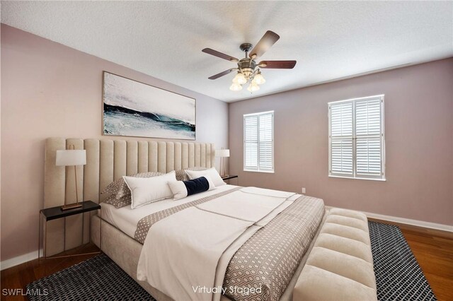5831 Cove Cir Unit 6, Naples, FL 34119 - bedroom with baseboards, wood finished floors, and ceiling fan