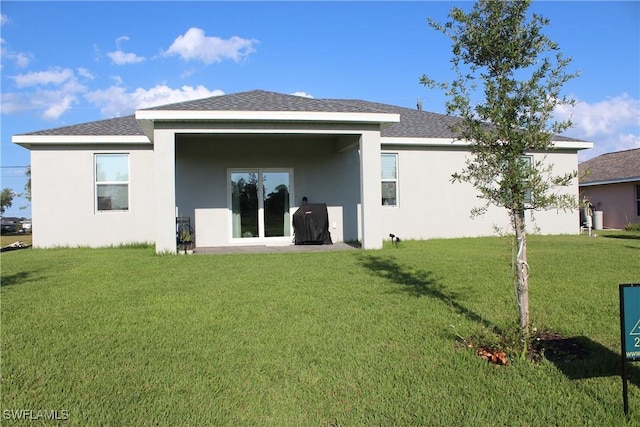 1530 NW 25th Ave, Cape Coral, FL 33993 - back of property with stucco siding, a yard, and a shingled roof