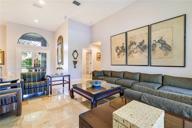 8241 Glenfinnan Cir, Fort Myers, FL 33912 - living room featuring french doors, a high ceiling, baseboards, and light tile patterned flooring