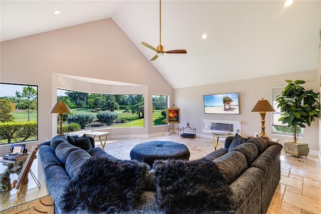 8241 Glenfinnan Cir, Fort Myers, FL 33912 - living room featuring high vaulted ceiling, stone tile flooring, plenty of natural light, a ceiling fan, and recessed lighting