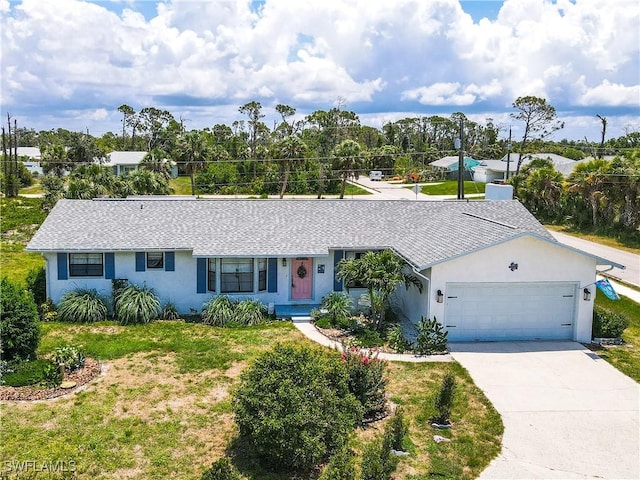 7690 Castleberry Ter, Englewood, FL 34224 - ranch-style home with a garage, driveway, stucco siding, a front yard, and roof with shingles