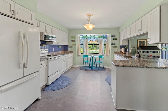 7690 Castleberry Ter, Englewood, FL 34224 - kitchen with white appliances, white cabinetry, a sink, dark stone countertops, and baseboards