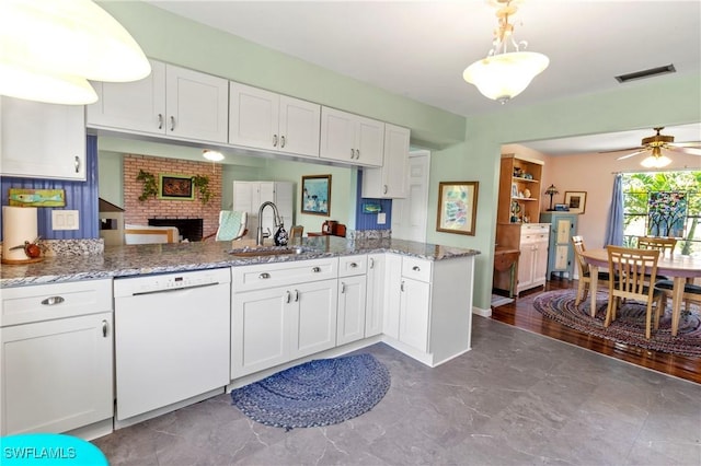 7690 Castleberry Ter, Englewood, FL 34224 - kitchen featuring dishwasher, a sink, white cabinets, and light stone countertops