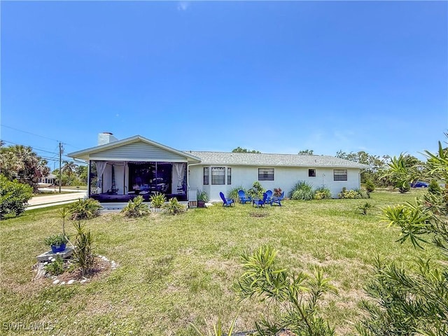 7690 Castleberry Ter, Englewood, FL 34224 - back of property featuring a yard, a sunroom, and stucco siding