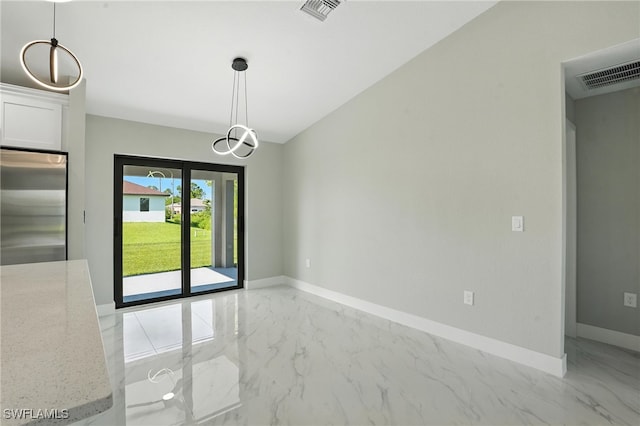 4011 7th St SW, Lehigh Acres, FL 33976 - unfurnished dining area with light marble finish floors and baseboards