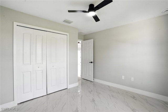 4011 7th St SW, Lehigh Acres, FL 33976 - unfurnished bedroom with a closet, marble finish flooring, and ceiling fan