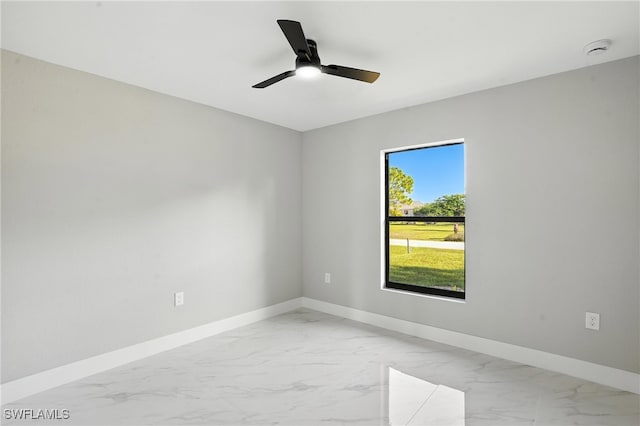 4011 7th St SW, Lehigh Acres, FL 33976 - unfurnished room with light marble finish flooring, a smoke detector, and ceiling fan