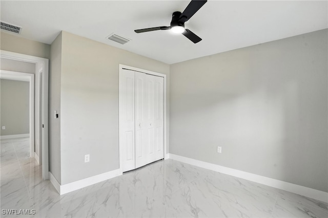 4011 7th St SW, Lehigh Acres, FL 33976 - unfurnished bedroom with marble look tiles, a closet, and ceiling fan