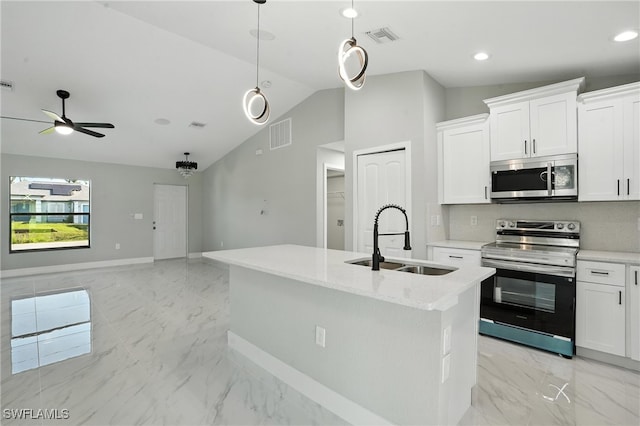 4011 7th St SW, Lehigh Acres, FL 33976 - kitchen with appliances with stainless steel finishes, lofted ceiling, ceiling fan, light marble finish floors, and a kitchen island with sink