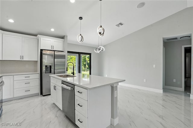 4011 7th St SW, Lehigh Acres, FL 33976 - kitchen with stainless steel appliances, light marble finish flooring, light countertops, hanging light fixtures, and a center island with sink