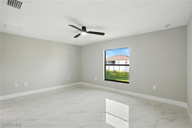 4011 7th St SW, Lehigh Acres, FL 33976 - empty room with light marble finish floors and ceiling fan