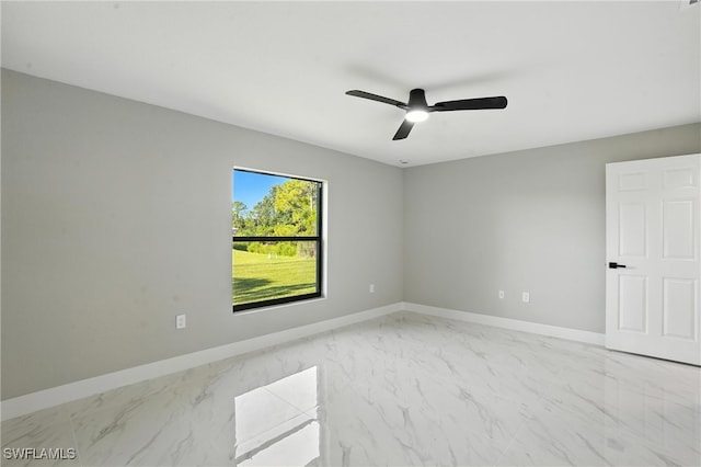 4011 7th St SW, Lehigh Acres, FL 33976 - spare room with marble look tiles and ceiling fan