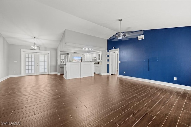 1311 SE 11th St, Cape Coral, FL 33990 - unfurnished living room with lofted ceiling, ceiling fan, dark wood finished floors, and baseboards
