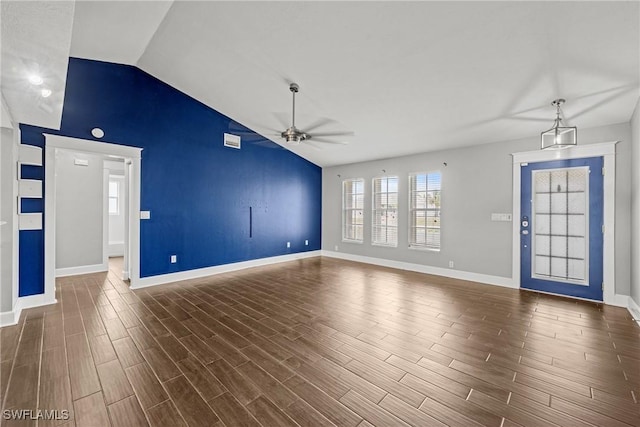1311 SE 11th St, Cape Coral, FL 33990 - unfurnished living room with a ceiling fan, baseboards, dark wood-style flooring, and high vaulted ceiling