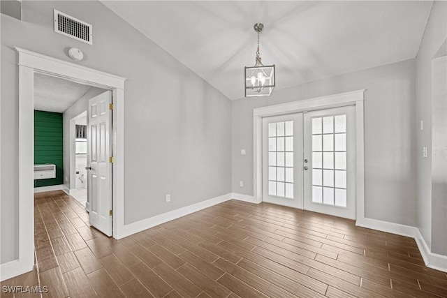 1311 SE 11th St, Cape Coral, FL 33990 - unfurnished dining area with french doors, a chandelier, baseboards, and dark wood finished floors