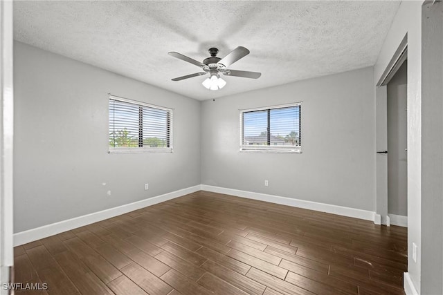 1311 SE 11th St, Cape Coral, FL 33990 - unfurnished bedroom featuring baseboards, dark wood finished floors, a textured ceiling, and ceiling fan