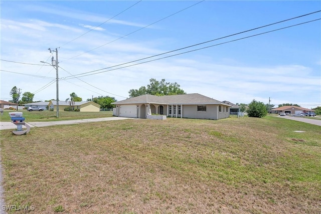 1311 SE 11th St, Cape Coral, FL 33990 - ranch-style house featuring concrete driveway, an attached garage, and a front yard