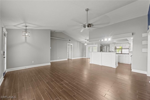 1311 SE 11th St, Cape Coral, FL 33990 - unfurnished living room with ceiling fan, dark wood-style flooring, baseboards, and vaulted ceiling