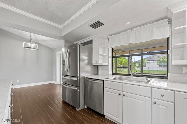 1311 SE 11th St, Cape Coral, FL 33990 - kitchen featuring appliances with stainless steel finishes, a sink, ornamental molding, baseboards, and white cabinets