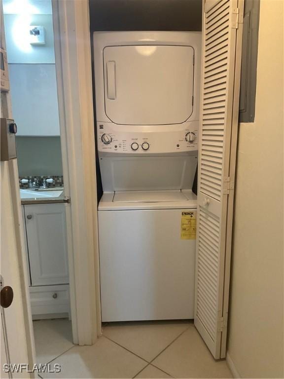 6897 Estero Blvd Unit 166, Fort Myers Beach, FL 33931 - washroom featuring stacked washer and clothes dryer and light tile patterned floors
