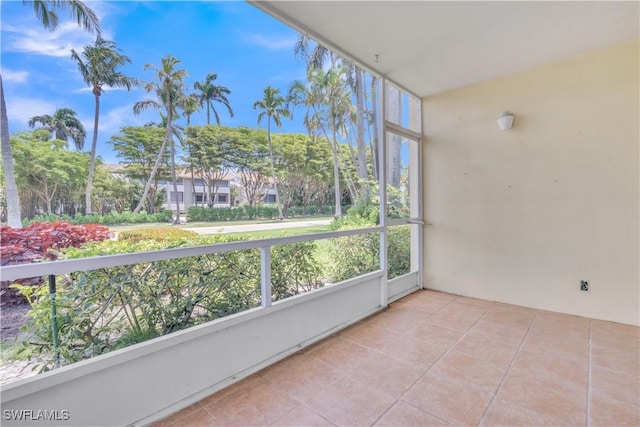 900 8th Ave S Unit 102, Naples, FL 34102 - unfurnished sunroom with tile patterned floors and plenty of natural light
