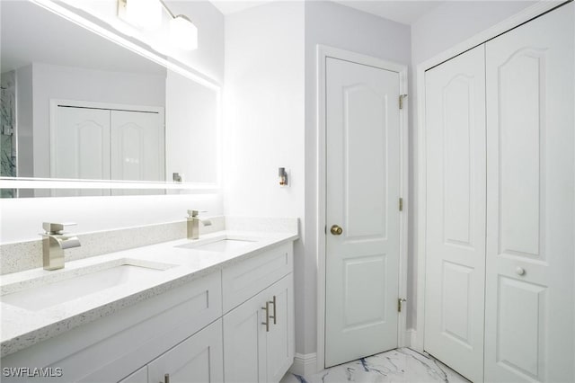 227 SW 48th Ter, Cape Coral, FL 33914 - bathroom featuring a closet, marble finish flooring, double vanity, and baseboards