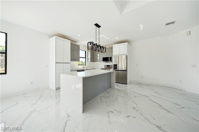 4309 NW 38th Ave, Cape Coral, FL 33993 - kitchen with modern cabinets, stainless steel appliances, baseboards, a kitchen island, and recessed lighting