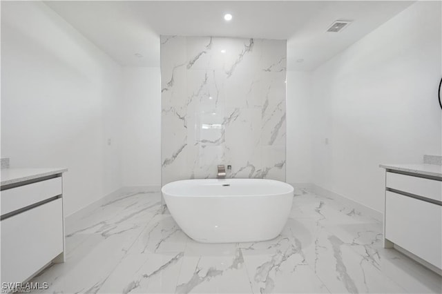 4309 NW 38th Ave, Cape Coral, FL 33993 - full bathroom featuring vanity, marble tiled flooring, a soaking tub, recessed lighting, and baseboards