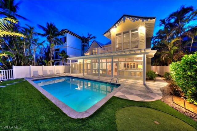 15009 Binder Dr, Captiva, FL 33924 - pool at night featuring a patio area and an area to practice putting