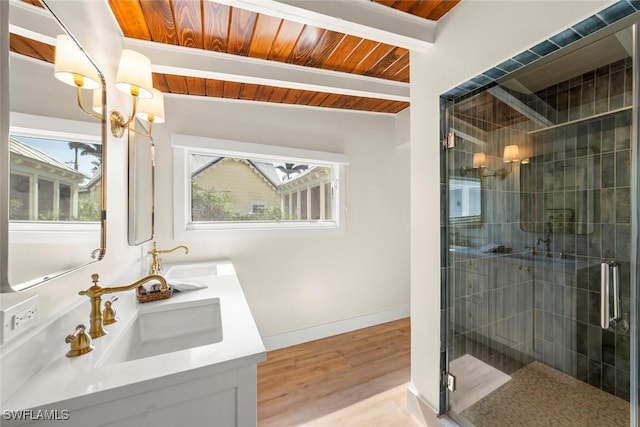 15009 Binder Dr, Captiva, FL 33924 - bathroom with double vanity, a shower stall, wooden ceiling with exposed beams, baseboards, and wood finished floors
