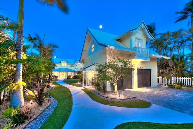 15009 Binder Dr, Captiva, FL 33924 - view of side of home featuring a balcony, a garage, and driveway