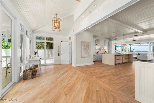 15009 Binder Dr, Captiva, FL 33924 - entryway featuring healthy amount of natural light, light wood-style floors, baseboards, and a chandelier